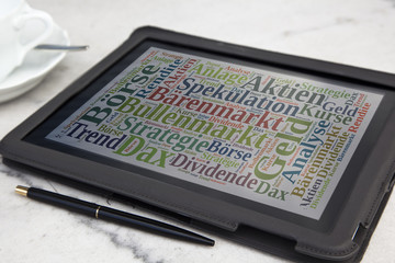 tablet with stock market word cloud