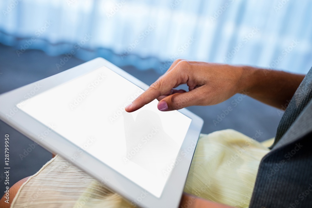 Poster close up of hand using a tablet