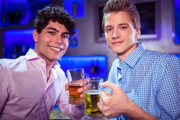 Portrait of smiling friends enjoying alcohol