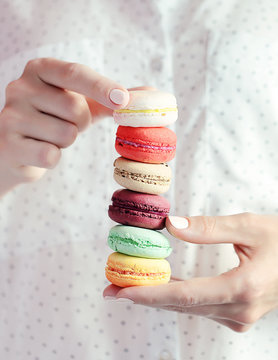 Woman holding macaroons