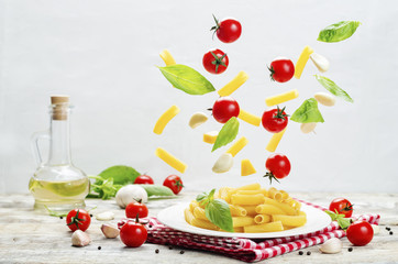 Flying pasta with tomatoes; garlic; cheese and basil