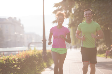 Fototapeta premium young multiethnic couple jogging in the city