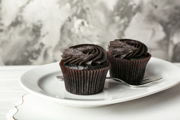 Tasty cupcakes on plate
