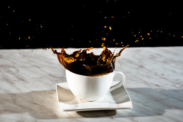 sugar cubes thrown into a cup of coffee
