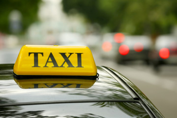 Taxi car on street, close up view