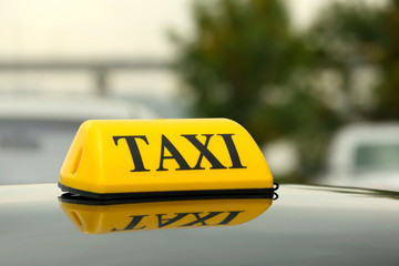 Taxi car on street, close up view