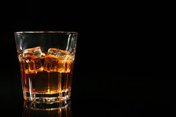 Glass of whisky on dark background