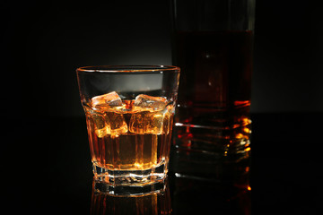 Glass of whisky on dark background