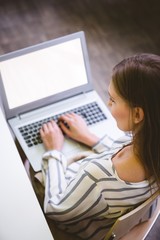High angle view of female executive with laptop at office