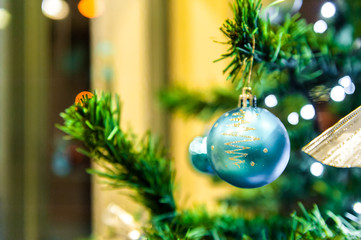 Christmas ball on the Christmass tree in the background with other ukrasheniyi and garlands. copyspace.