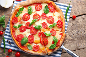 Delicious pizza on kitchen table