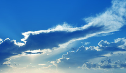 Naklejka na ściany i meble Beautiful blue sky with sunbeams and clouds