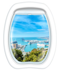 Plane window on port of Malaga from the Gibralfaro Castle, Andalusia, Spain, from a plane through the porthole. Copy space.