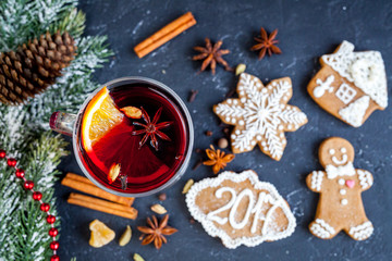 Christmas mulled wine with spices in cup on dark background