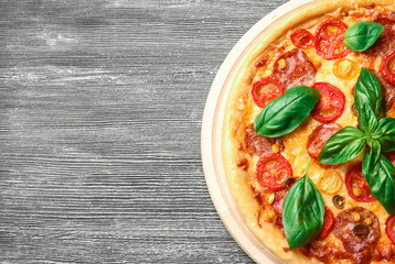 Delicious pizza on wooden table