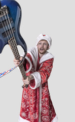young man in the image of Santa Claus with a guitar in his hands