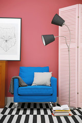 Blue armchair in stylish interior