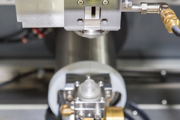 Fototapeta na wymiar High precision CNC wire cut machine working, operator machining