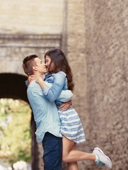 Fototapeta premium Beautiful young couple outdoors on blurred background