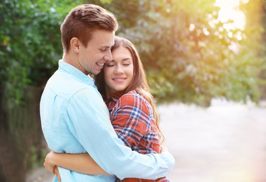 Beautiful young couple outdoors on blurred background