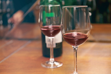 Glasses of red wine on bar counter