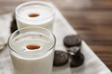 Tasty milk shake with cookies on table