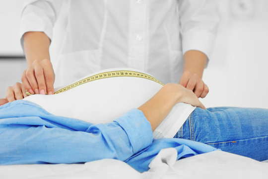 Doctor measuring pregnant belly