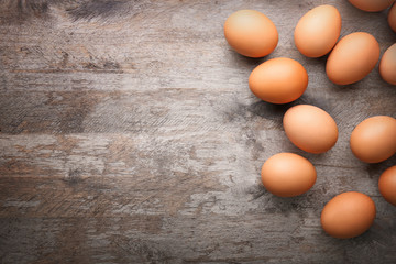 Raw eggs on wooden background