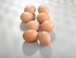 Raw eggs on grey background