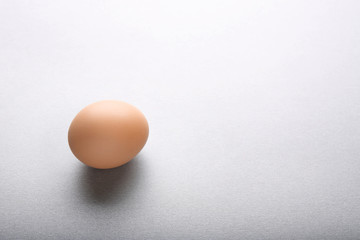 Raw egg on grey background