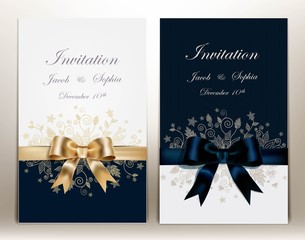two pretty wedding invitation with ribbon and bow.