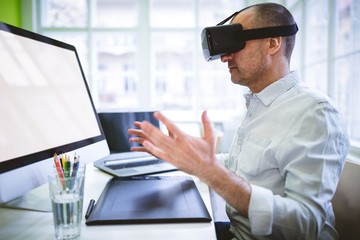 Naklejka na ściany i meble Graphic designer using virtual reality headset 