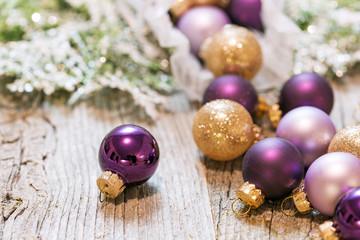 Multi-colored Christmas toys and Christmas tree closeup.....New Year's toys in bulk on a wooden background, card.
