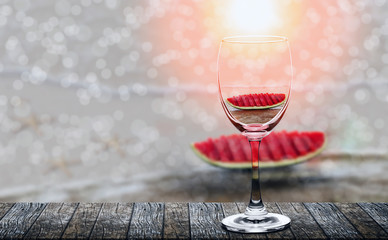 slices of the watermelon teflected in wine glass