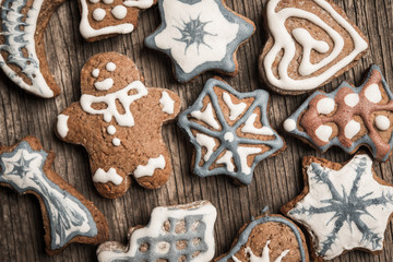 Colorfully Christmas cookies on rustic wooden background, gingerman and tree