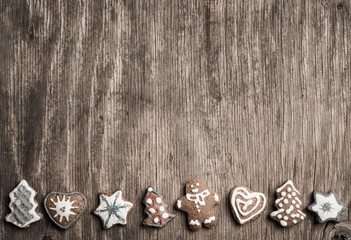Colorfully Christmas cookies on rustic wooden background