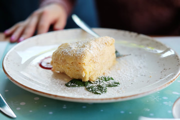 A piece of napoleon cake made of thin layers of pastry