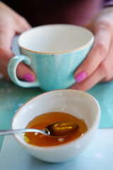 Woman drinking tea with honey