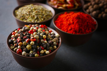 Different spices in bowls on table