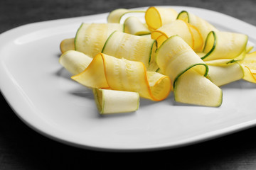 Slices of zucchini on white plate
