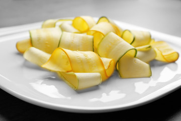 Slices of zucchini on white plate
