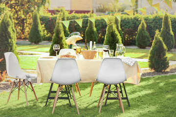 Table with food and drinks served for picnic