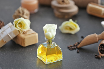 Spa concept. Aroma oil and flowers on grey table