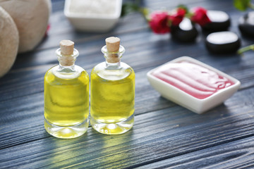 Spa concept. Aroma oil and scrub on blue wooden background