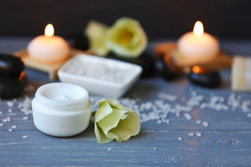 Cream with spa treatments on blue wooden table