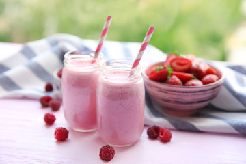 Berry milkshakes on wooden table