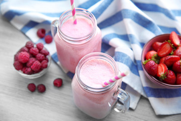 Berry milkshakes on wooden table