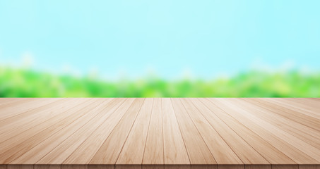 Empty wood table top on green leaf and blue sky background for display or montage product