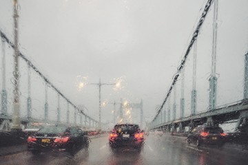 Travel in rain through the bridge. - 128813973