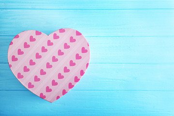 Heart shaped gift box on blue background